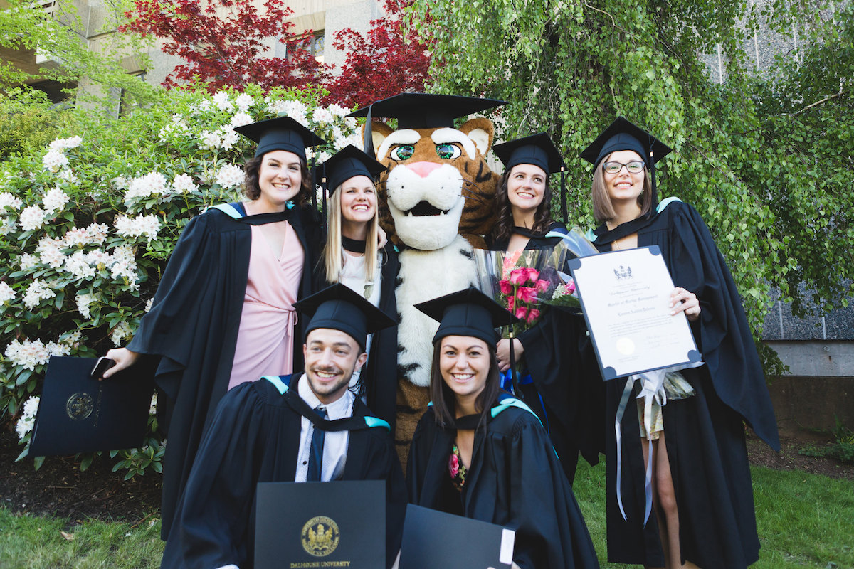 A group of graduating students with a Tiger mascot.