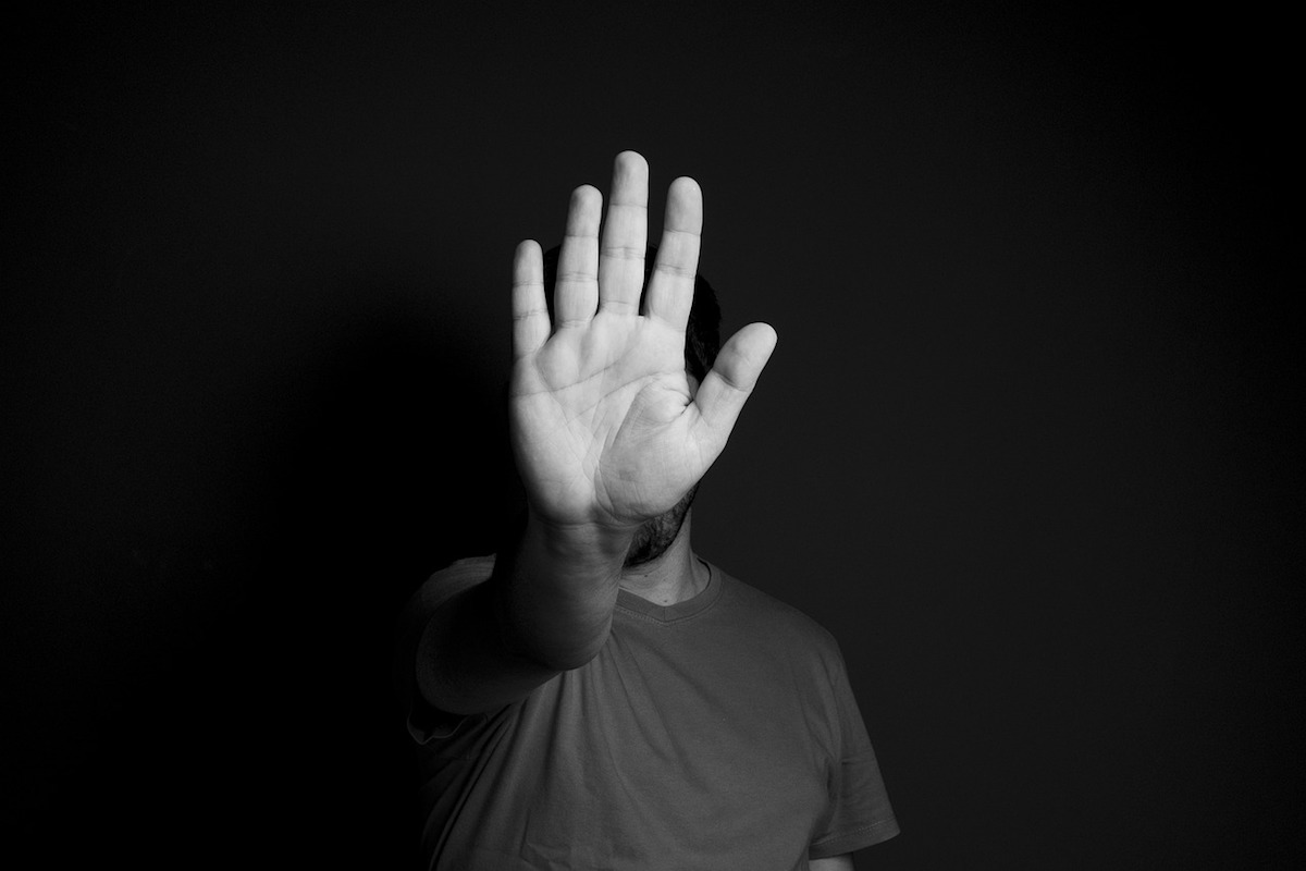 Man holding up his hand in a stop gesture