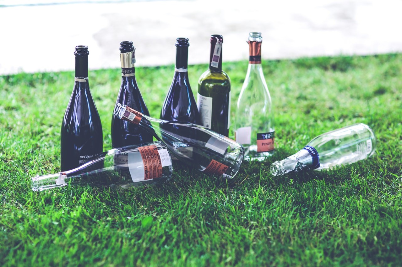 Empty alcohol bottles on a patch of grass