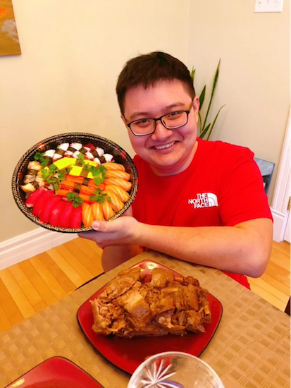 Student in red shirt holding a plate of food