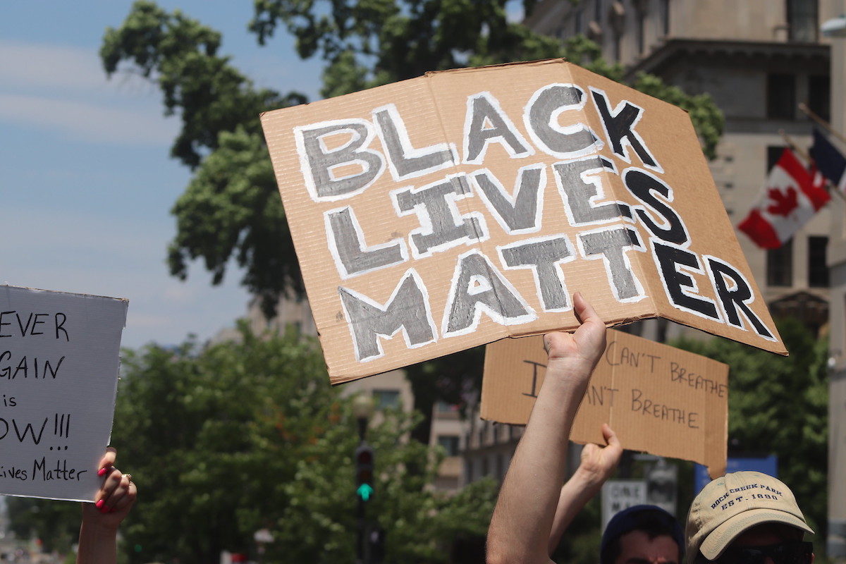 A person holding a sign that says Black Lives Matter at a protest in Washington, D.C.