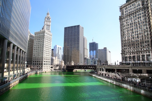 Chicago river dyed green with skyscrapers in the background