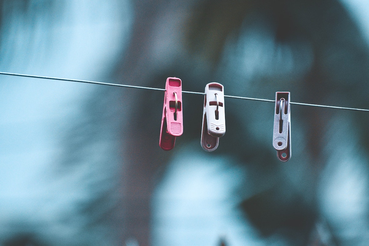 Clothes pins hanging on a laundry line.