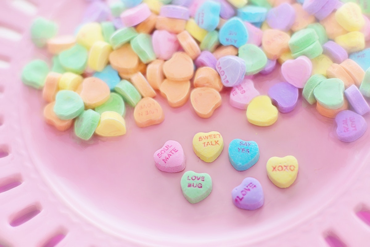 Heart-shaped candies on a pink plate