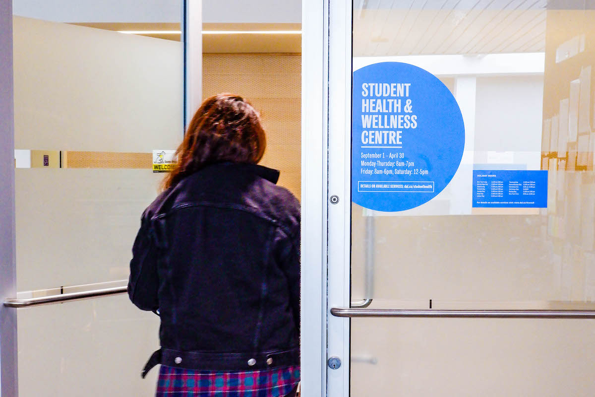 A student walking into the Student Health & Wellness Centre