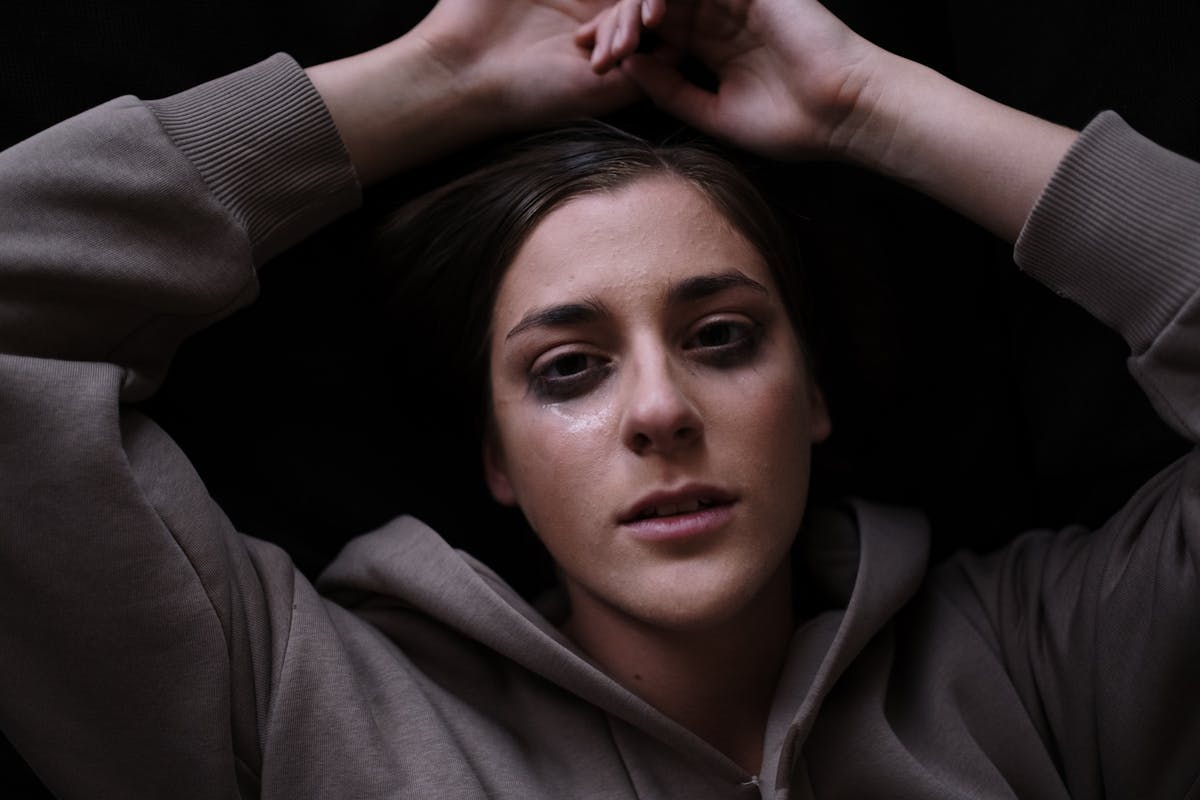 Young woman staring at the camera with tears on her face