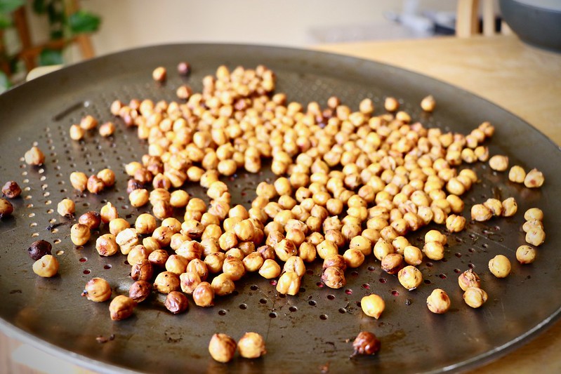 Chickpeas roasting on a pan.